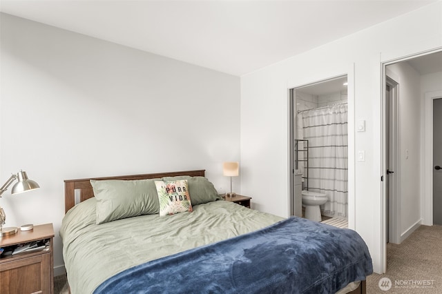 carpeted bedroom featuring ensuite bathroom