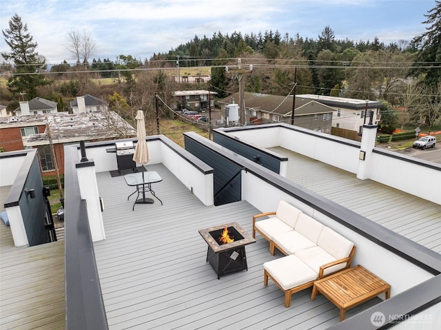 deck with an outdoor living space with a fire pit