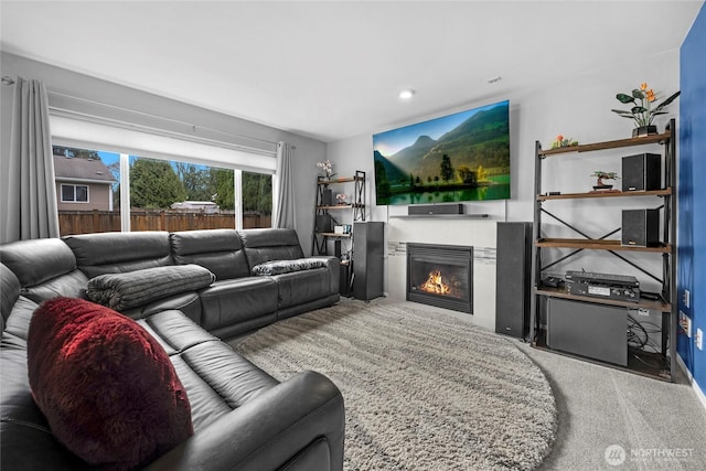 living room featuring a glass covered fireplace