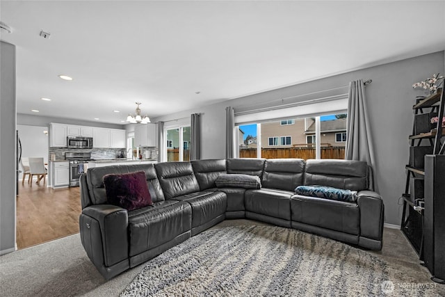 living room with an inviting chandelier, wood finished floors, and recessed lighting