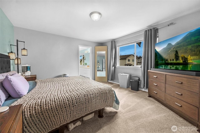 bedroom featuring light carpet and baseboards