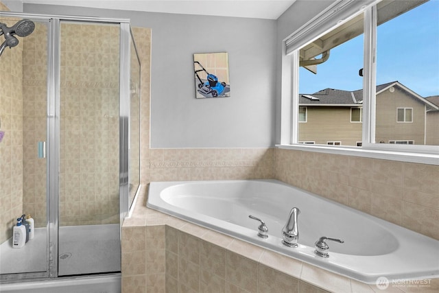 bathroom with a garden tub and a shower stall