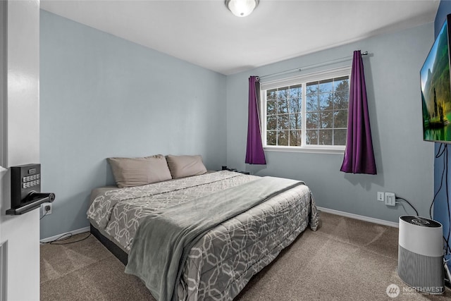 carpeted bedroom featuring baseboards