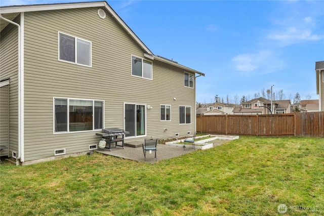 back of house with crawl space, a patio, a lawn, and fence