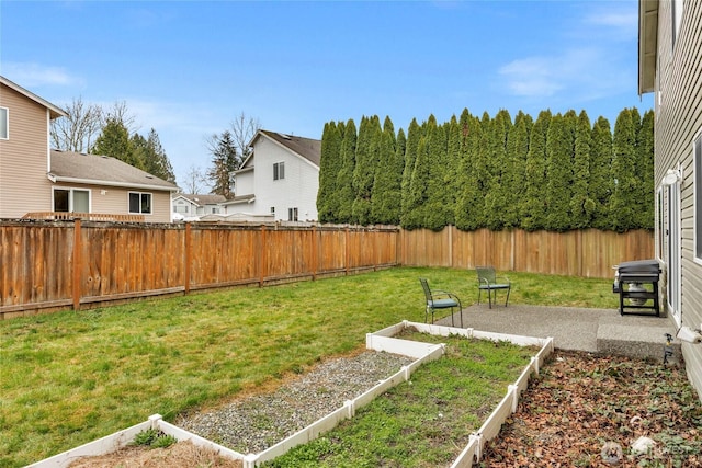 view of yard with a fenced backyard and a vegetable garden