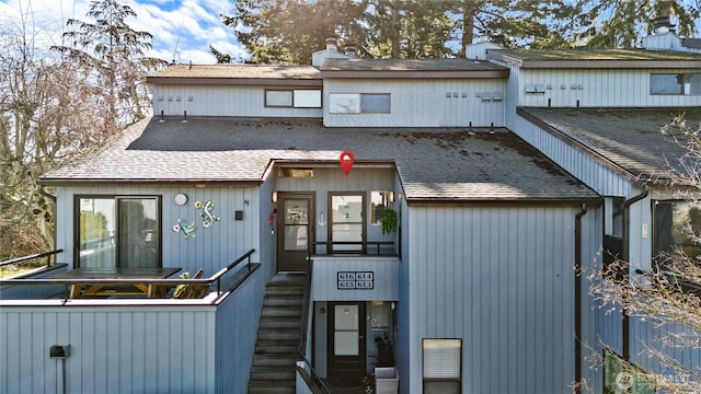 view of front of property featuring roof with shingles