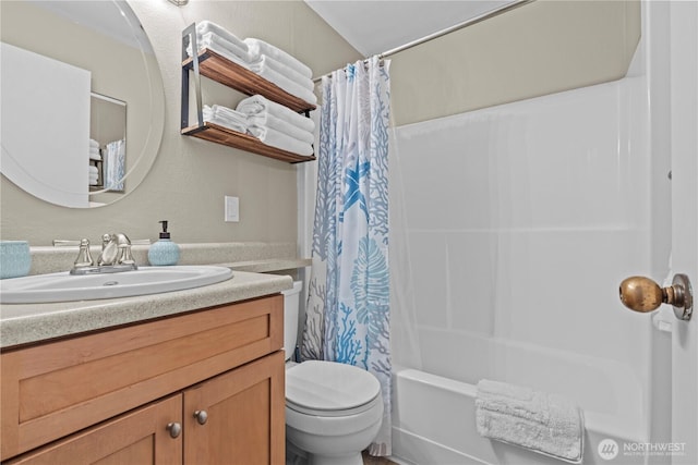 full bathroom featuring shower / bath combination with curtain, vanity, and toilet