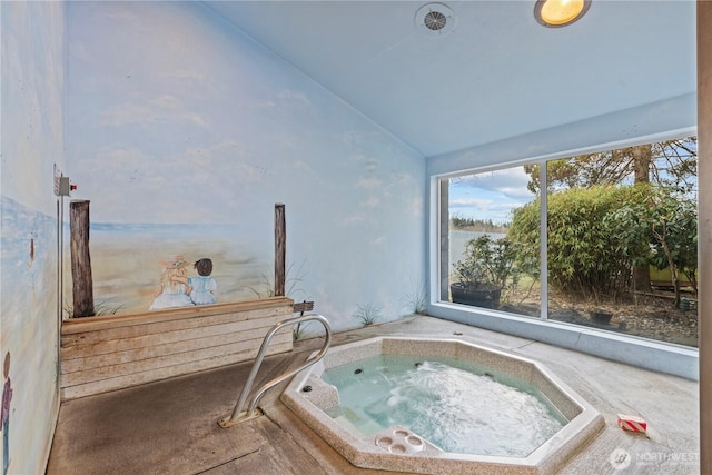 exterior space featuring lofted ceiling and a jacuzzi