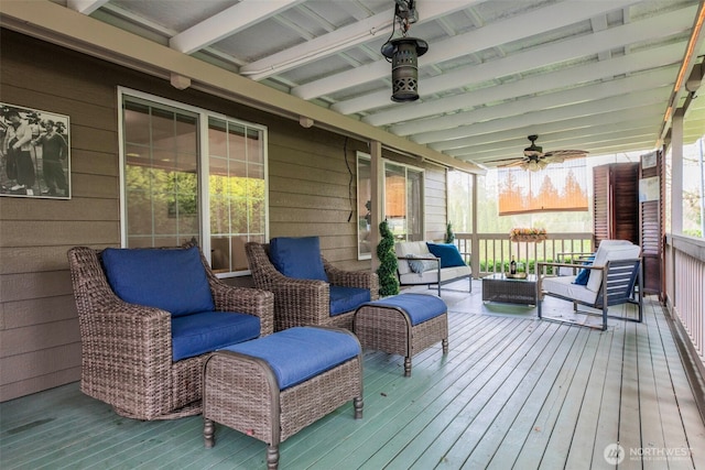 wooden terrace featuring an outdoor living space and ceiling fan