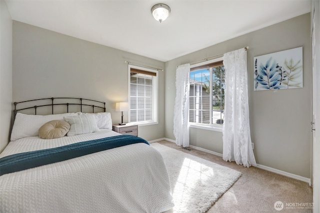 bedroom with carpet flooring, visible vents, and baseboards