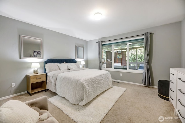 bedroom with visible vents, baseboards, and light carpet