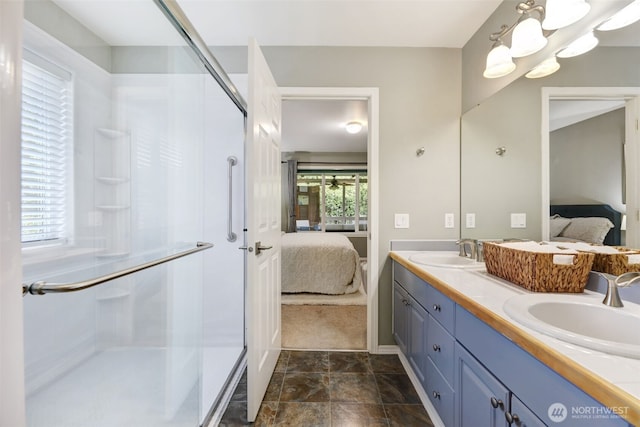 full bath with a sink, plenty of natural light, a shower stall, and ensuite bathroom