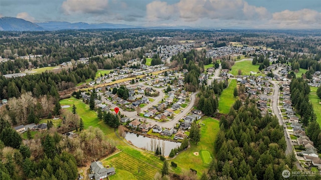 bird's eye view featuring a forest view and a water and mountain view