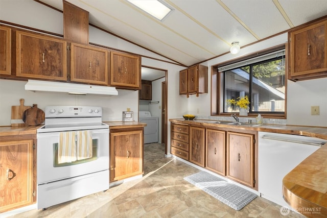 kitchen featuring white appliances, lofted ceiling, washer / clothes dryer, under cabinet range hood, and a sink