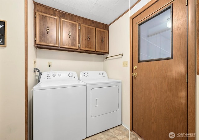 laundry room with washing machine and dryer and cabinet space