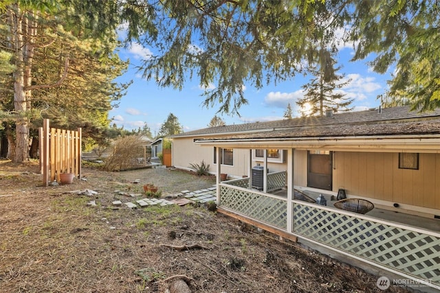 rear view of house with a patio, central AC unit, and fence