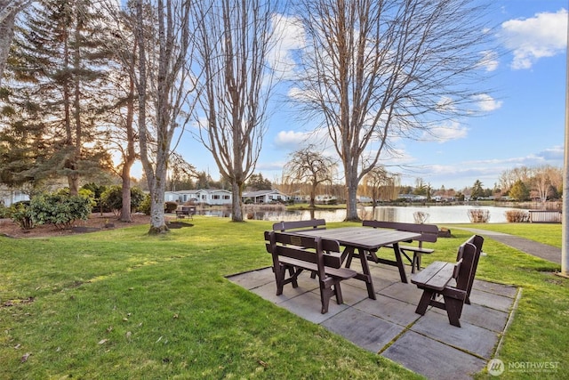 view of yard with a patio area and a water view