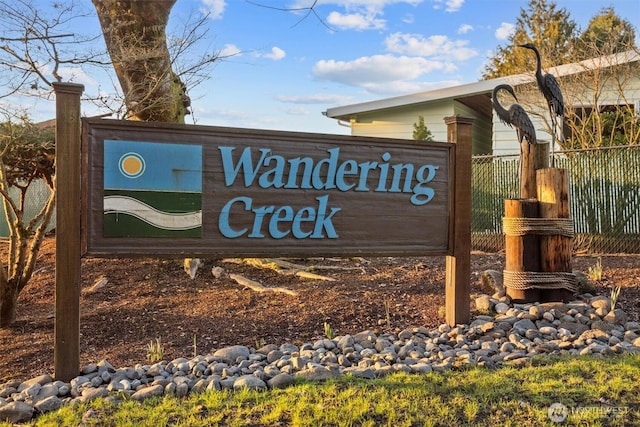 community sign featuring fence