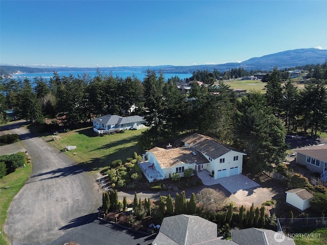 drone / aerial view with a water and mountain view