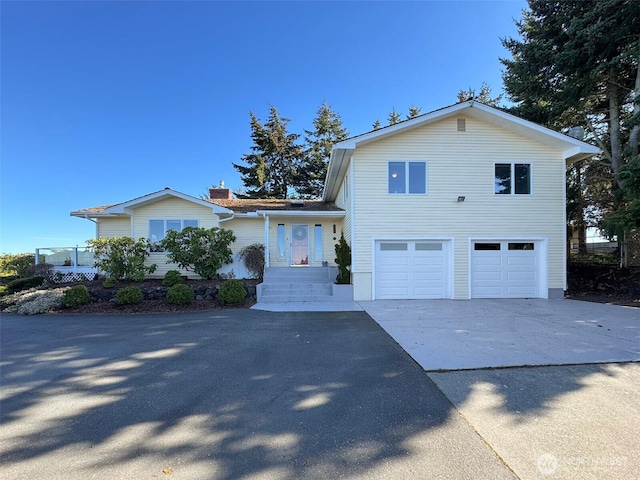 tri-level home featuring driveway and a garage