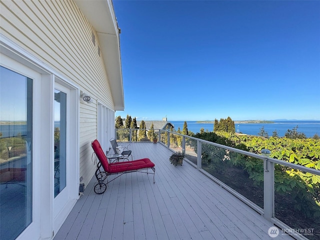 wooden terrace featuring a water view