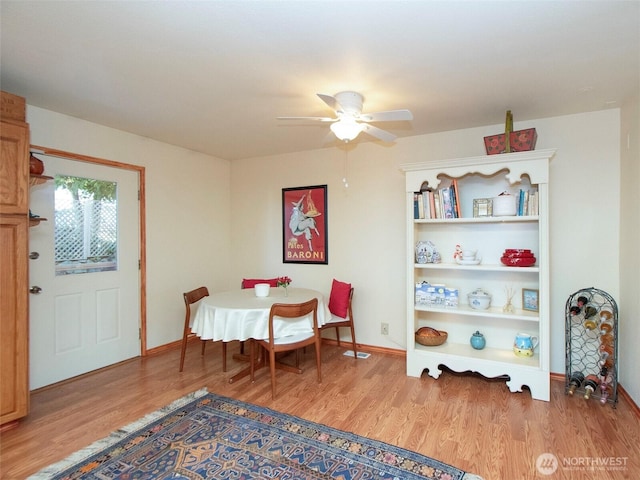 dining space with ceiling fan, baseboards, and wood finished floors