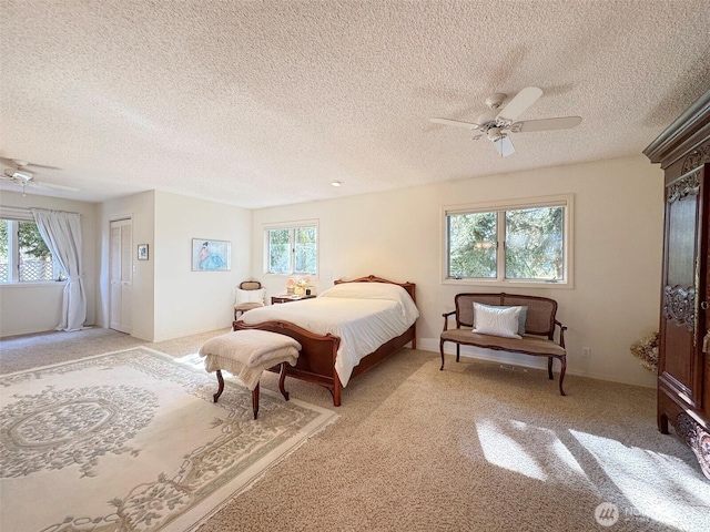 bedroom featuring light carpet, ceiling fan, and baseboards