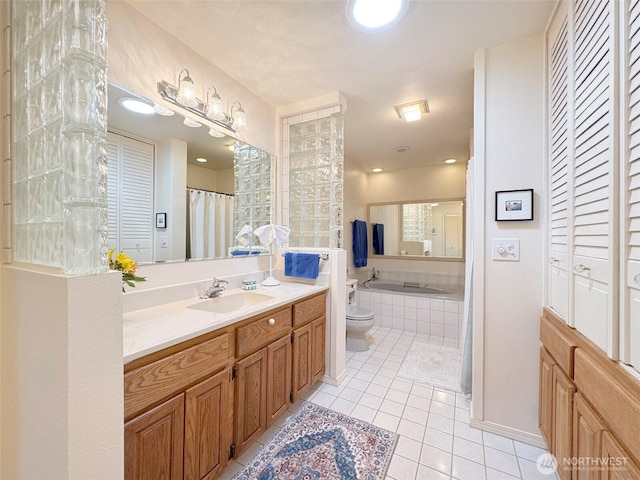 bathroom featuring toilet, a closet, tile patterned flooring, and vanity