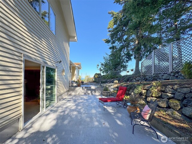 view of patio featuring fence