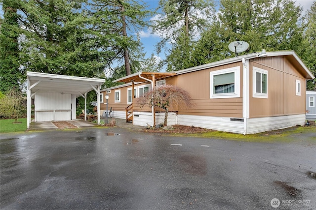 manufactured / mobile home featuring crawl space, driveway, and a carport