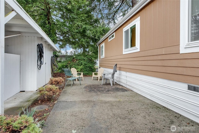 view of side of home featuring a patio area