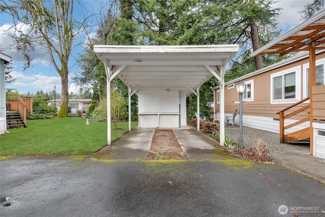 view of car parking with a detached carport and driveway