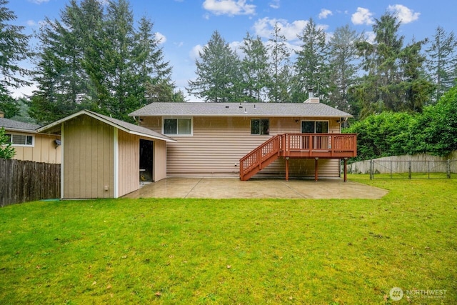 back of property with a yard, a fenced backyard, a patio, and stairs