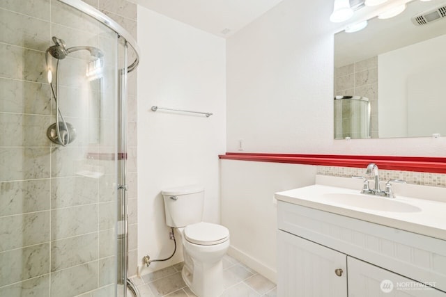 bathroom featuring tile patterned flooring, toilet, vanity, visible vents, and a stall shower