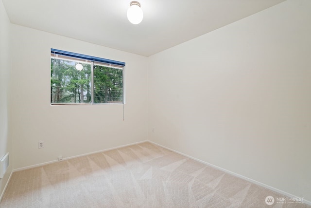 unfurnished room with light carpet