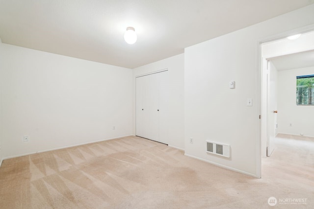 spare room with visible vents and light carpet