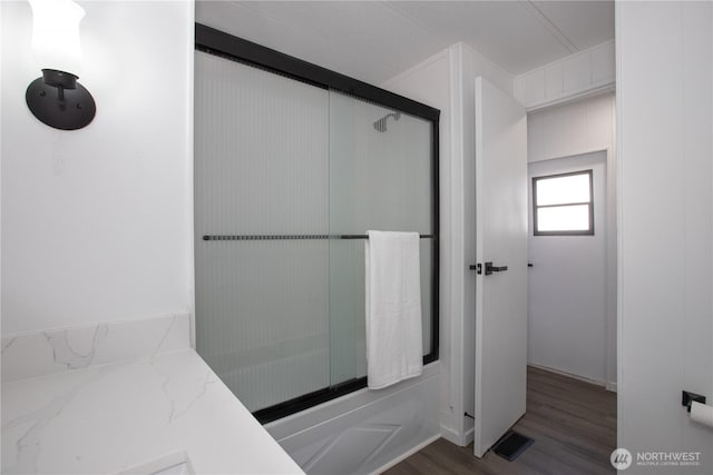 bathroom featuring wood finished floors, visible vents, and an enclosed shower