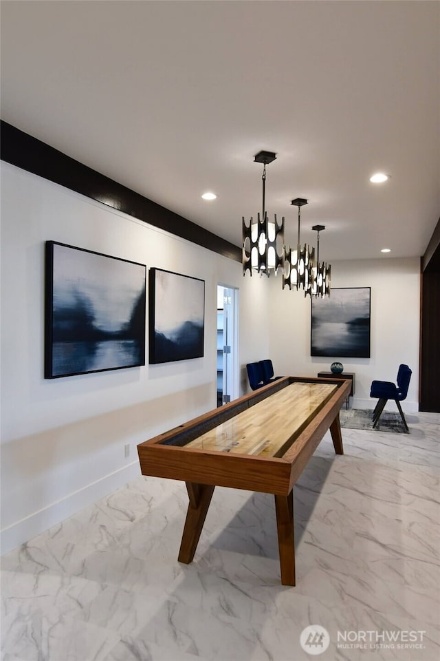 recreation room featuring recessed lighting, marble finish floor, and baseboards