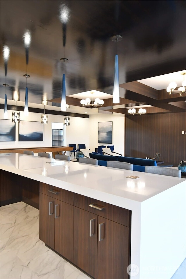 kitchen with marble finish floor, light countertops, open floor plan, and modern cabinets