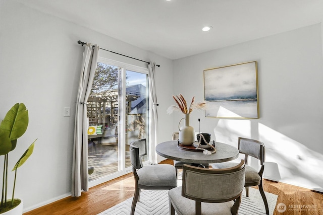 dining space featuring light wood-type flooring, baseboards, and recessed lighting