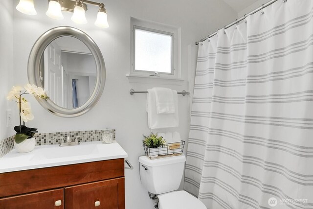 full bath with toilet and vanity