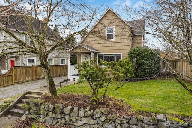 view of front of home with a front lawn and a fenced backyard