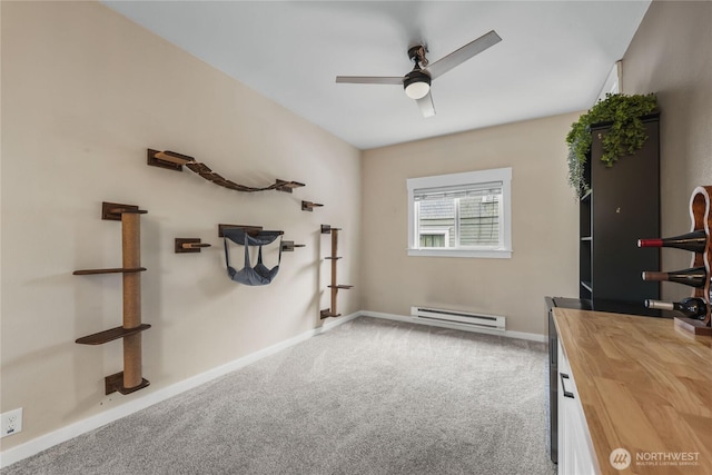 carpeted home office with baseboards, baseboard heating, and ceiling fan