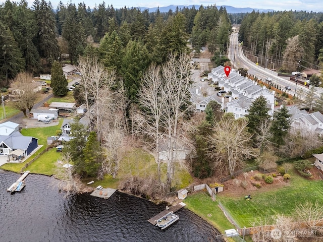 bird's eye view featuring a view of trees and a water view