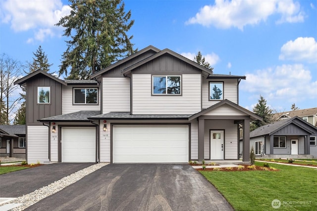 view of front of house with a front lawn, a garage, board and batten siding, and driveway