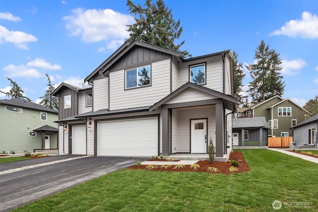 view of front of house featuring a front yard, a garage, board and batten siding, and driveway