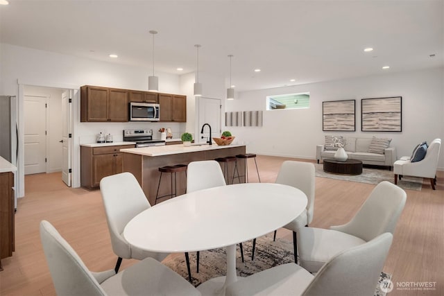 dining area featuring recessed lighting and light wood finished floors