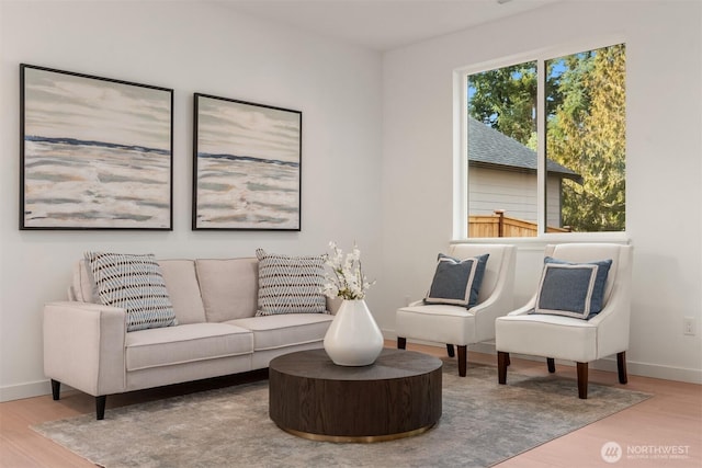 living area with wood finished floors and baseboards