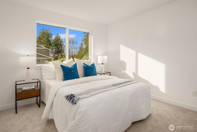 bedroom featuring baseboards and light carpet