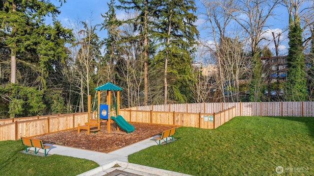 view of jungle gym featuring a yard and fence private yard